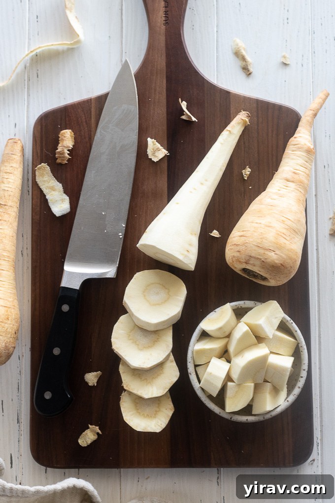 Sliced and chopped parsnips on a cutting board, prepared for cooking