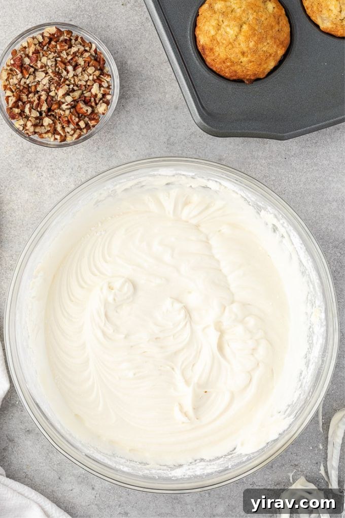 Dreamy Cream Cheese Frosting 3 Basic cream cheese frosting being mixed in a large bowl, showcasing its creamy texture.