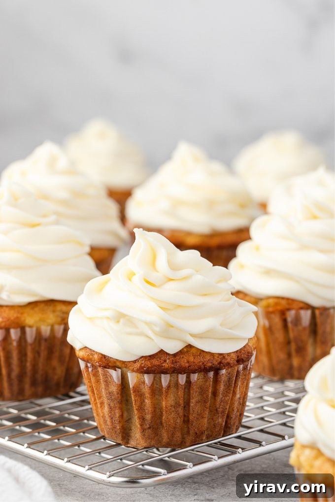 Dreamy Cream Cheese Frosting 7 Delightful cupcakes topped with homemade cream cheese frosting, showcasing its beautiful texture.
