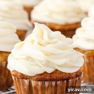 Cream cheese frosting expertly piped on a cupcake, ready to be enjoyed.