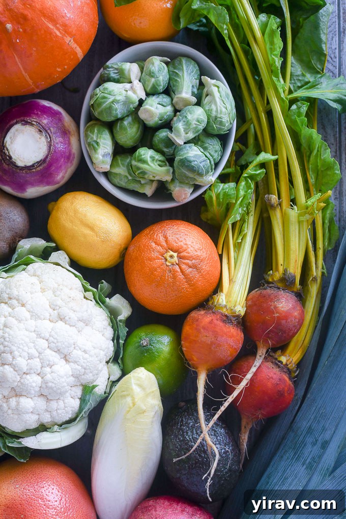Assortment of winter vegetables and fruits including citrus, beets, and cauliflower