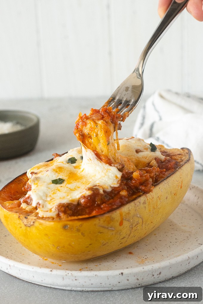 Noodle-Free Lasagna Bake 10 Fork pulling strands of spaghetti squash lasagna