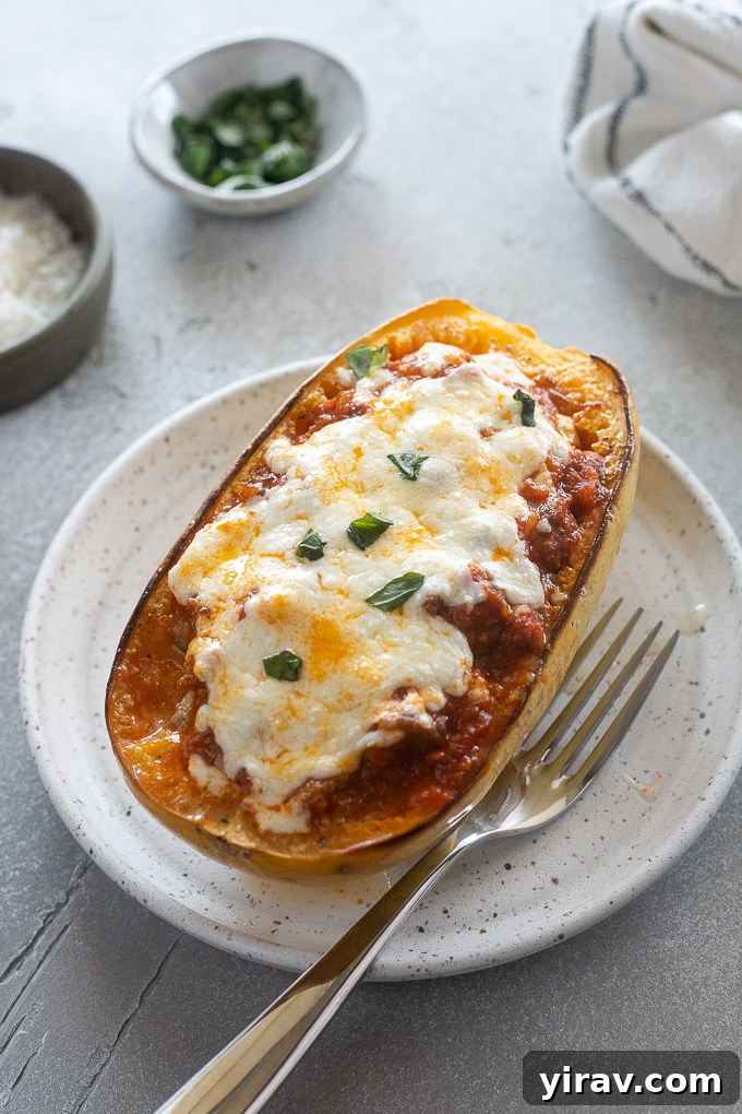 Noodle-Free Lasagna Bake 9 Spaghetti squash lasagna boat on a plate with a fork