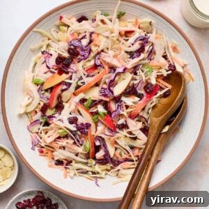 Overhead shot of apple fennel slaw in a bowl with wooden servers.