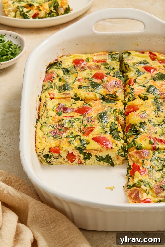 Effortless Bacon and Egg Bake 3 Sections of egg bake with bacon cut into squares, showing off the fluffy texture and colorful vegetables.