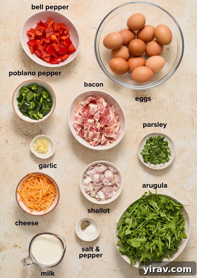 Effortless Bacon and Egg Bake 4 Fresh ingredients laid out for making the bacon and egg casserole, including eggs, bacon, peppers, shallot, garlic, arugula, milk, and cheese.
