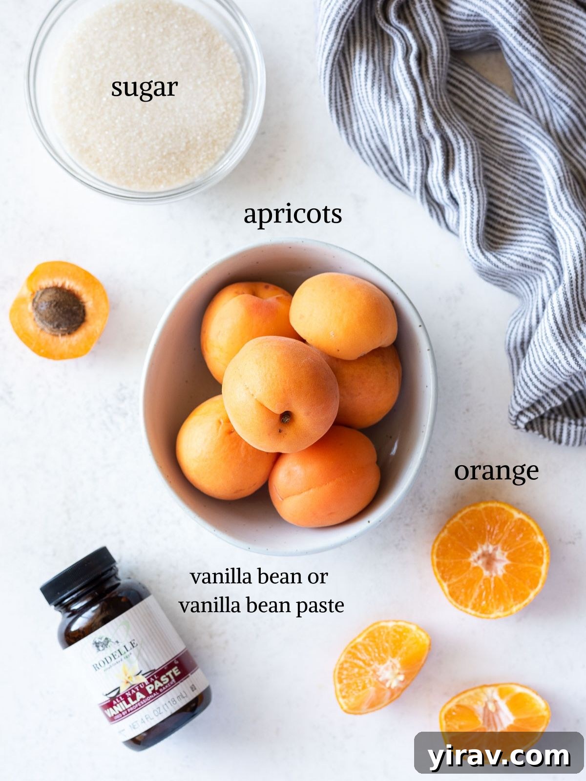 Handcrafted Golden Apricot Jam 4 An overhead shot showing all the simple ingredients for apricot jam: fresh apricots, granulated sugar, an orange, and vanilla.