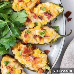 Corn dip stuffed jalapenos with bacon on top
