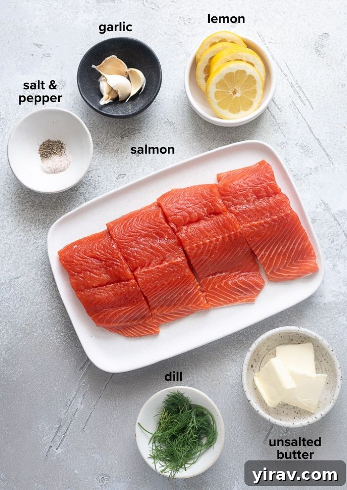 Irresistible Garlic Butter Salmon 4 Various ingredients for garlic butter salmon, including salmon fillets, butter, garlic, dill, and lemon.