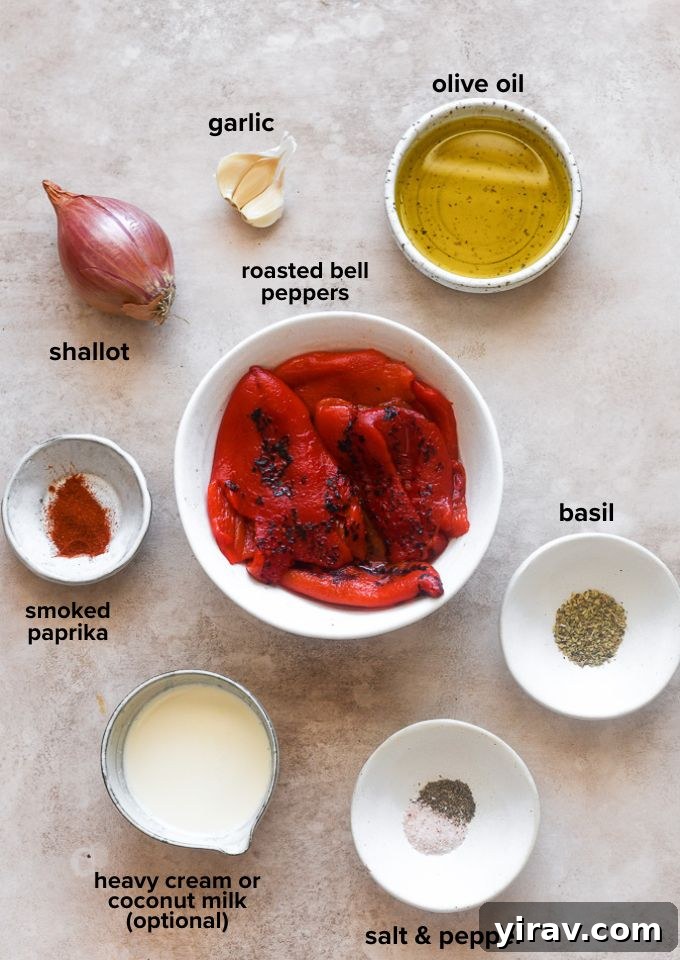 Roasted red pepper sauce recipe ingredients laid out on a white surface.