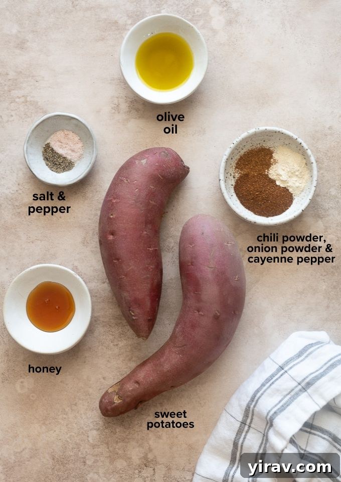 All the recipe ingredients for air fryer roasted sweet potatoes laid out on a wooden board.