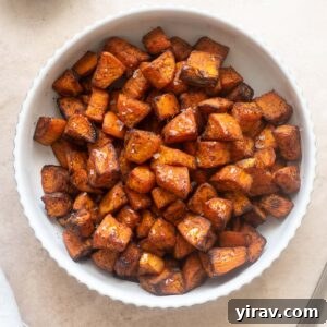 Air fryer roasted sweet potatoes in a white bowl, ready to serve.
