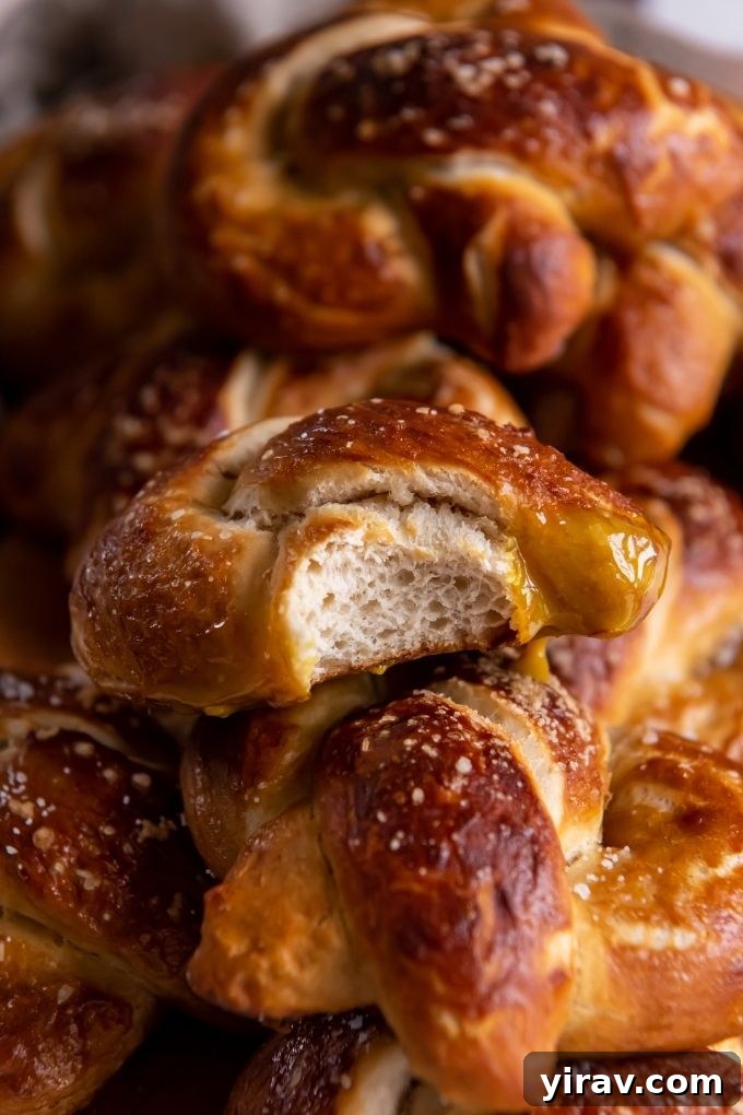 A beautifully composed shot of homemade soft pretzels cooling on a wire rack, showcasing their intricate twists and perfectly baked, glossy surfaces.