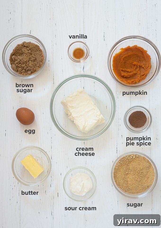 Bite Sized Pumpkin Cheesecake Treats 4 A selection of fresh ingredients laid out for making mini pumpkin cheesecakes, including cream cheese, pumpkin puree, and spices.