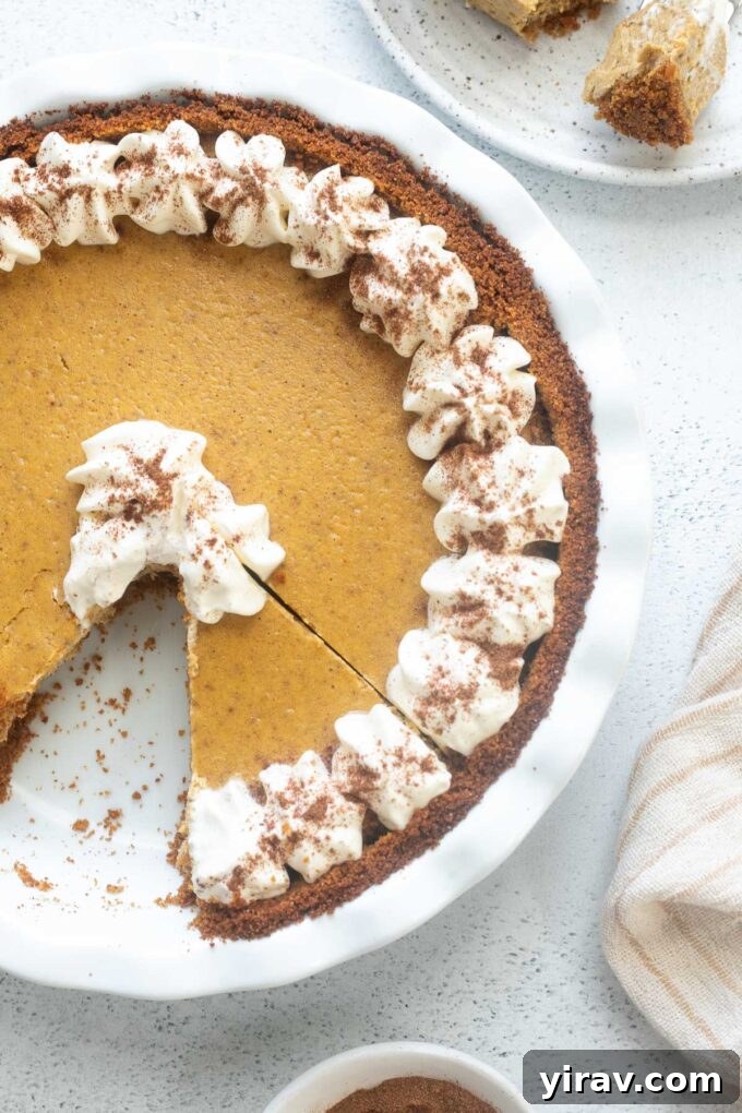 Autumn Spice Pumpkin Cheesecake Delight 3 Pumpkin pie cheesecake with whipped cream piped on top.