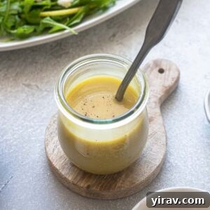 Sparkling Honey Champagne Dressing 7 Honey champagne vinaigrette in a jar with a spoon.