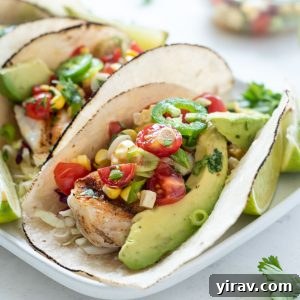 Grilled Fish Taco topped with cherry tomato salsa and avocado