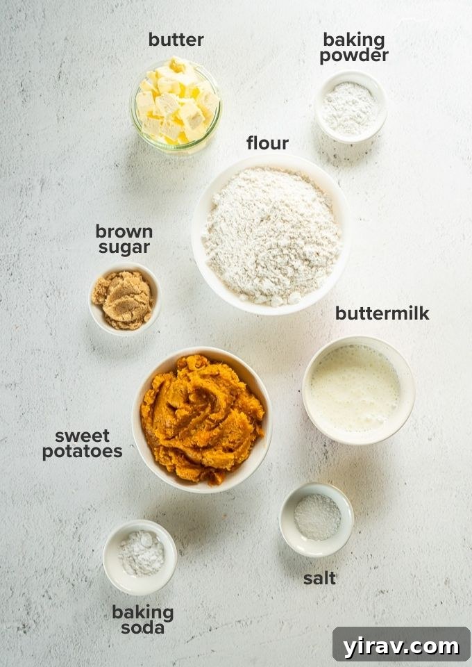 Assortment of sweet potato biscuit ingredients laid out on a wooden surface.