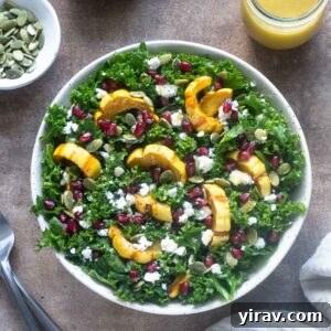 Delicata squash salad in a bowl with dressing alongside.