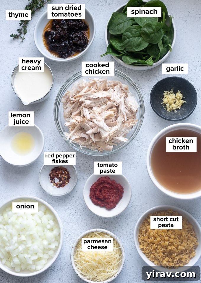 Cupid's Comfort Chicken Soup 4 A selection of fresh ingredients including chicken, spinach, sun-dried tomatoes, and spices laid out on a table.