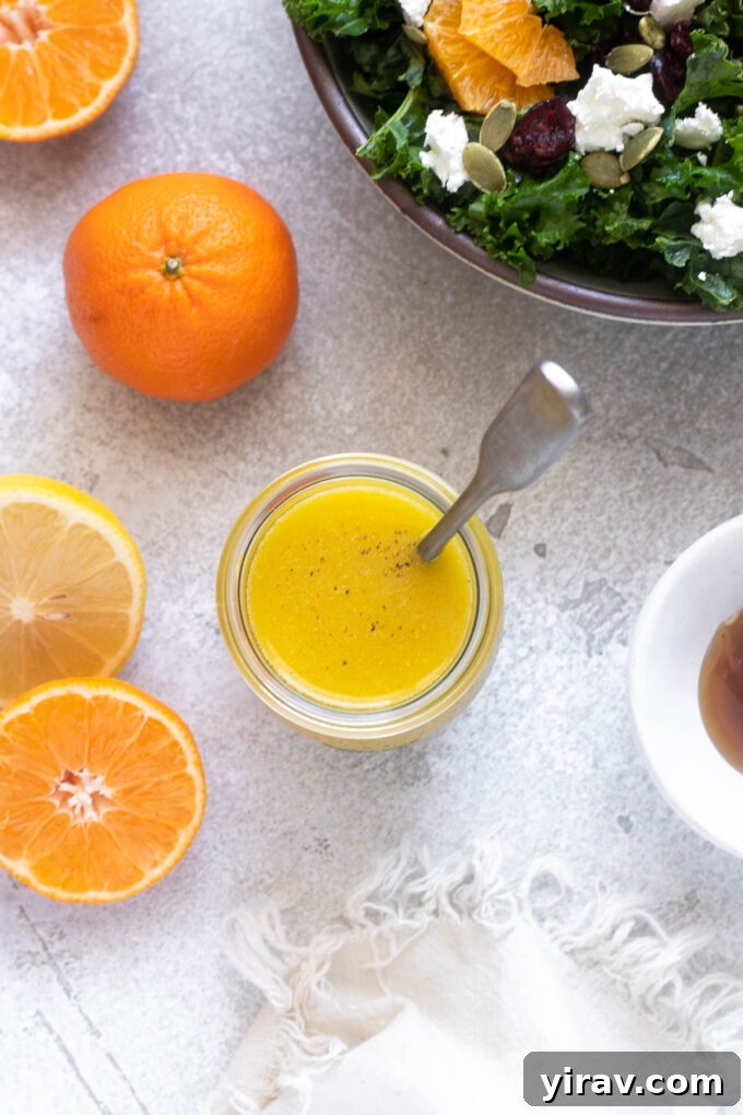 Zesty Citrus Vinaigrette 6 Freshly emulsified orange dressing in a jar with a spoon, ready to serve.