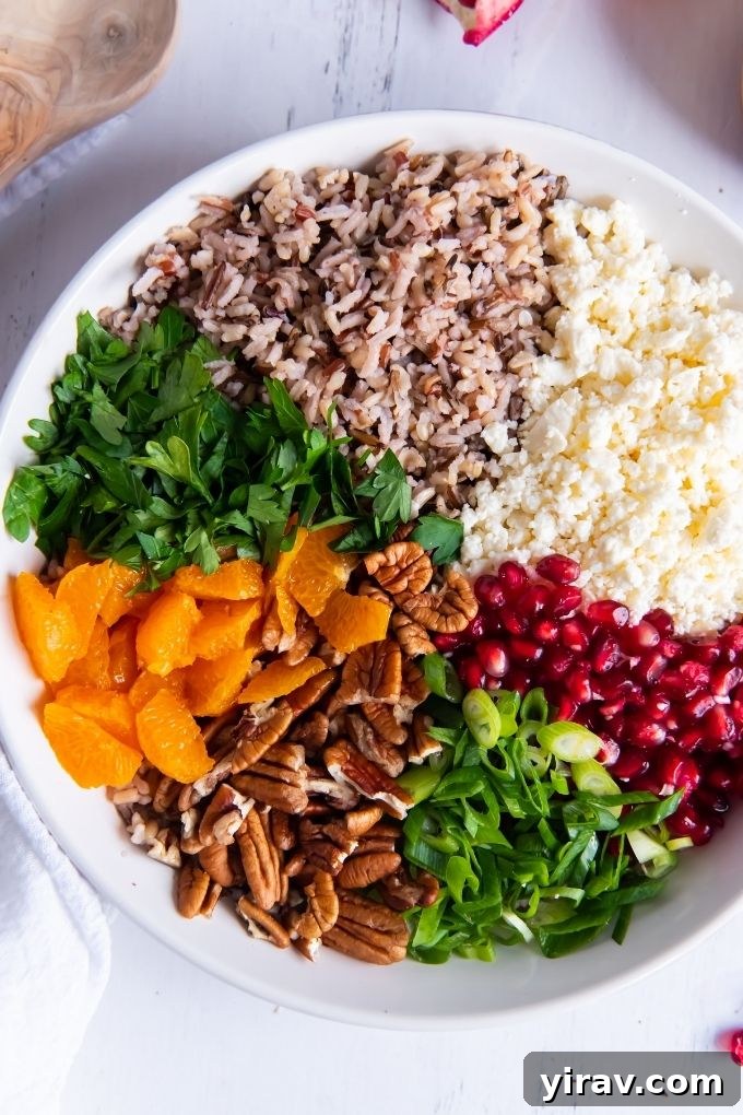 Wild rice salad ingredients segmented in a bowl