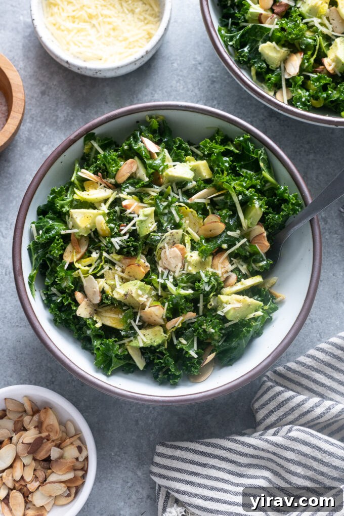 A bowl of fresh kale and raw brussels sprout salad with a fork, ready to be enjoyed.