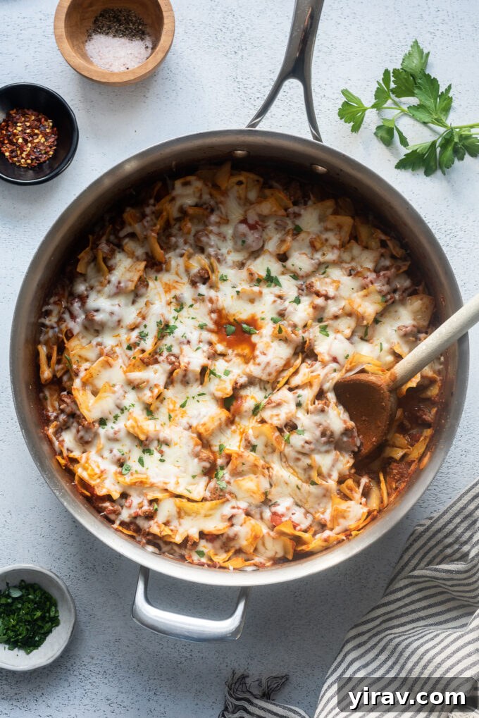 Hearty Beef and Cabbage Bake 2 Hearty Cabbage and Ground Beef Casserole, garnished with fresh herbs and melted cheese, served in a cast iron skillet.