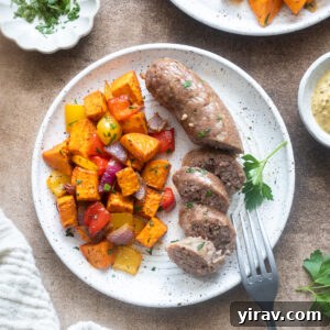 Sheet pan sausage, peppers and sweet potatoes on a plate.