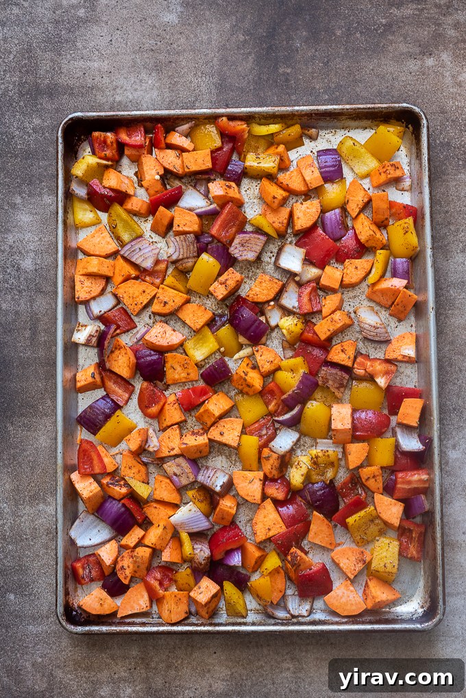 Seasoned vegetables on baking sheet.