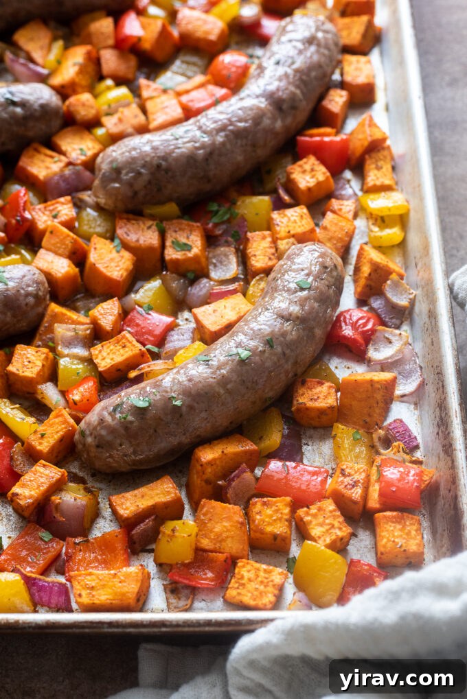 One pan roasted sausage and vegetables on sheet pan.