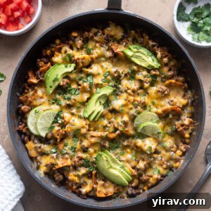 Ground beef enchilada casserole in skillet.