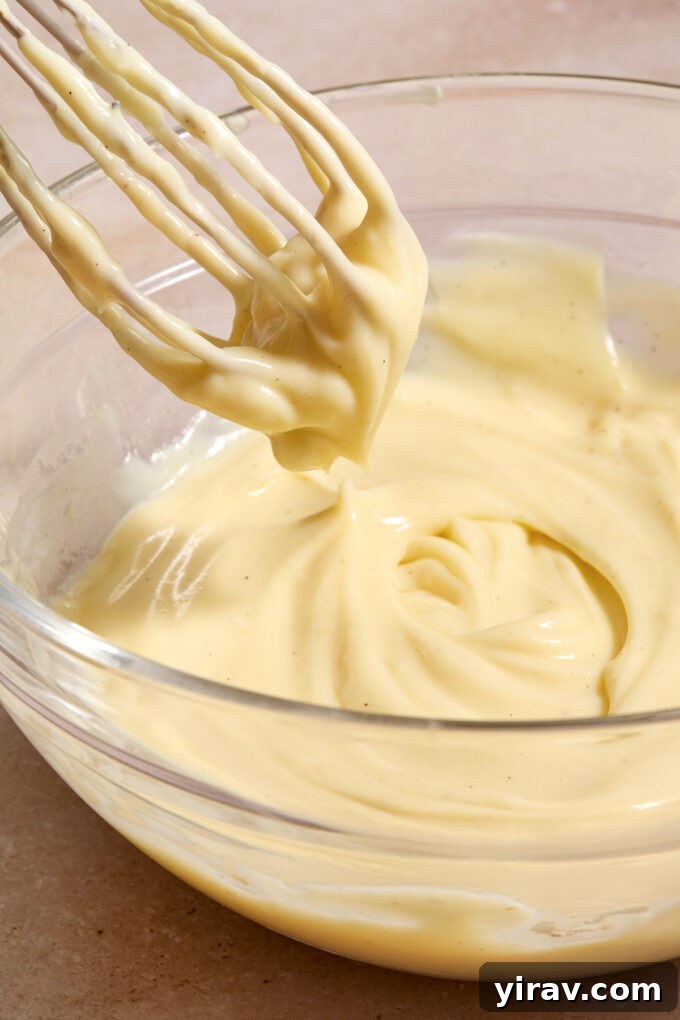 Bowl of creme patissiere with a whisk.