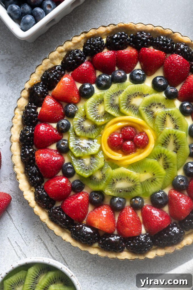 French fruit tart featuring a creamy pastry cream and beautifully arranged fresh fruit