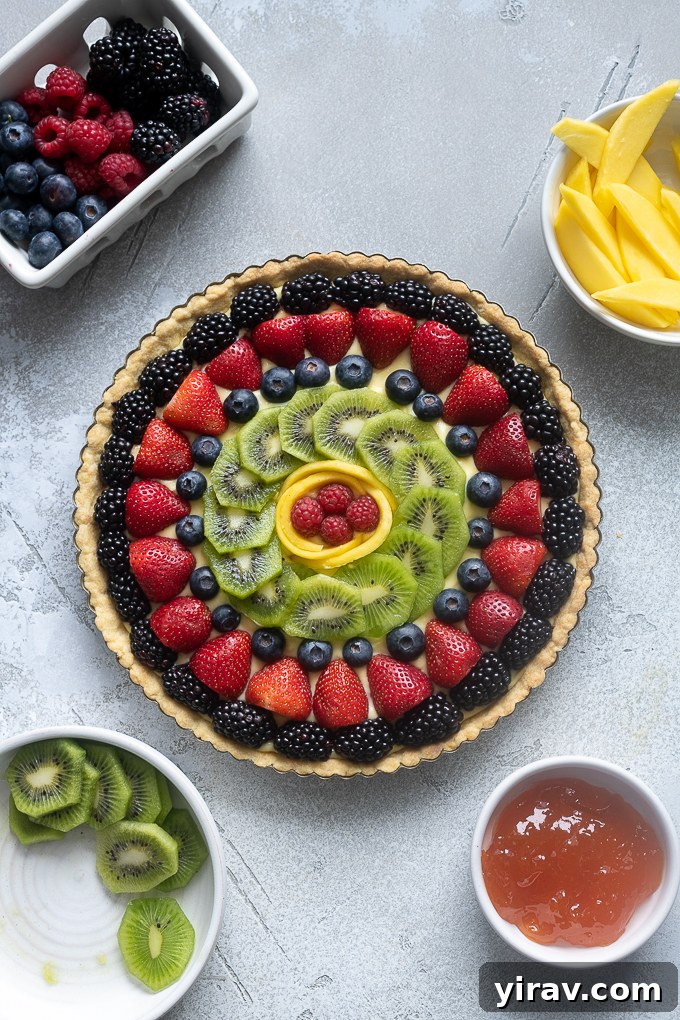 French fruit tart artfully decorated with an array of fresh fruit slices