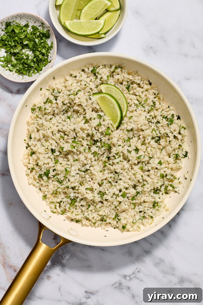 Riced cauliflower with cilantro and lime in a skillet.