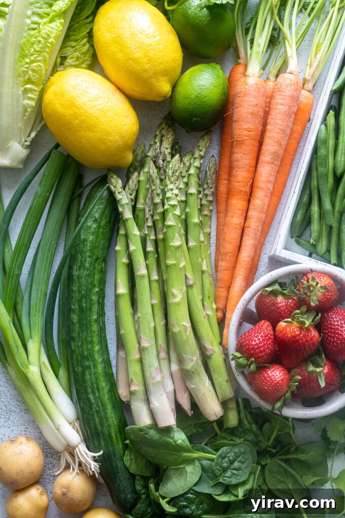 May seasonal produce including asparagus, strawberries, and carrots, artfully arranged on a rustic wooden surface, highlighting their fresh appeal.