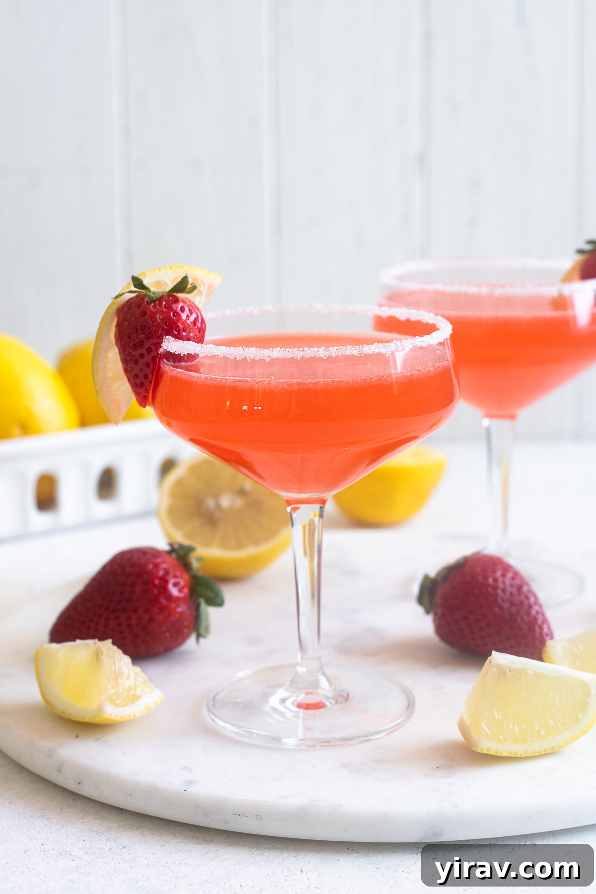 A beautifully crafted Fresh Strawberry Lemon Drop Martini, served in a coupe glass, sparkling with freshness.