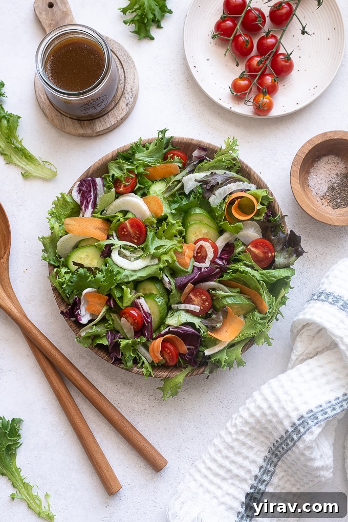 Insalata Mista beautifully tossed with dressing in a large serving bowl, ready to be enjoyed immediately.