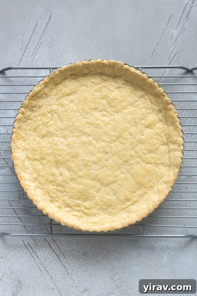 Buttery Sweet Tart Dough 11 A freshly baked Pâte Sucrée tart crust cooling on a wire rack.