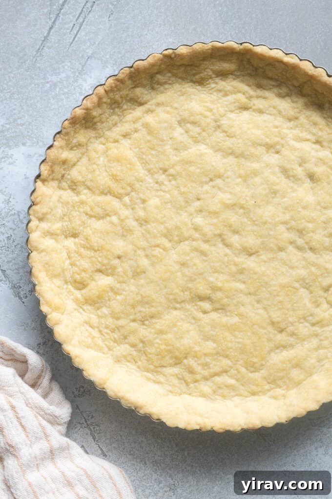 Buttery Sweet Tart Dough 3 A raw Pâte Sucrée tart dough perfectly pressed into a metal tart pan, ready for baking.