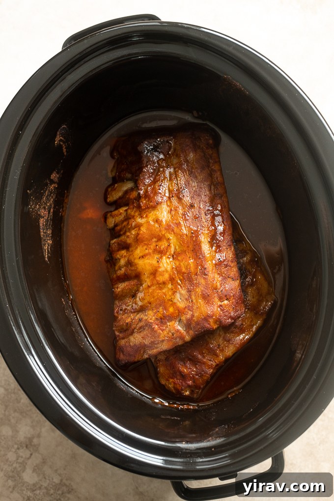Cooked bbq baby back ribs in slow cooker.