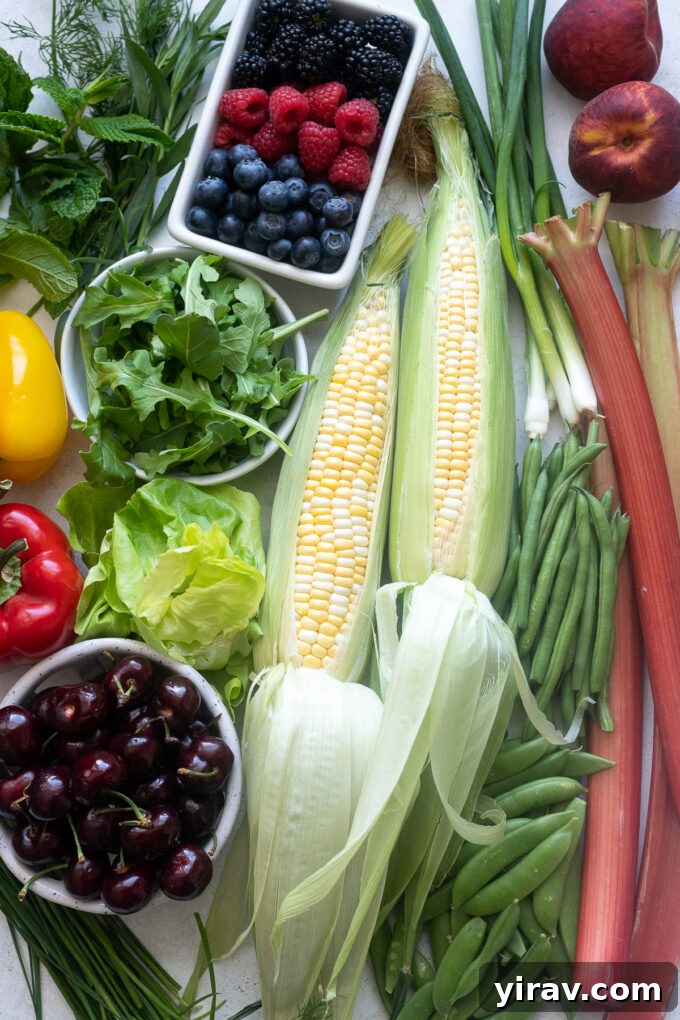 June Harvest Highlights 2 A vibrant display of fresh June seasonal vegetables and fruits, including berries, peas, carrots, and greens.