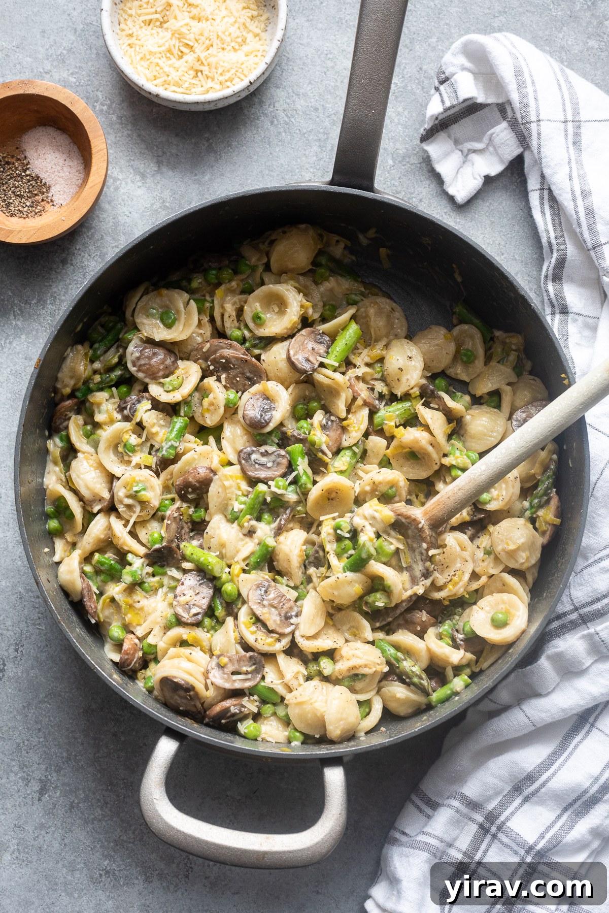 One pot pasta primavera with spring vegetables in skillet.