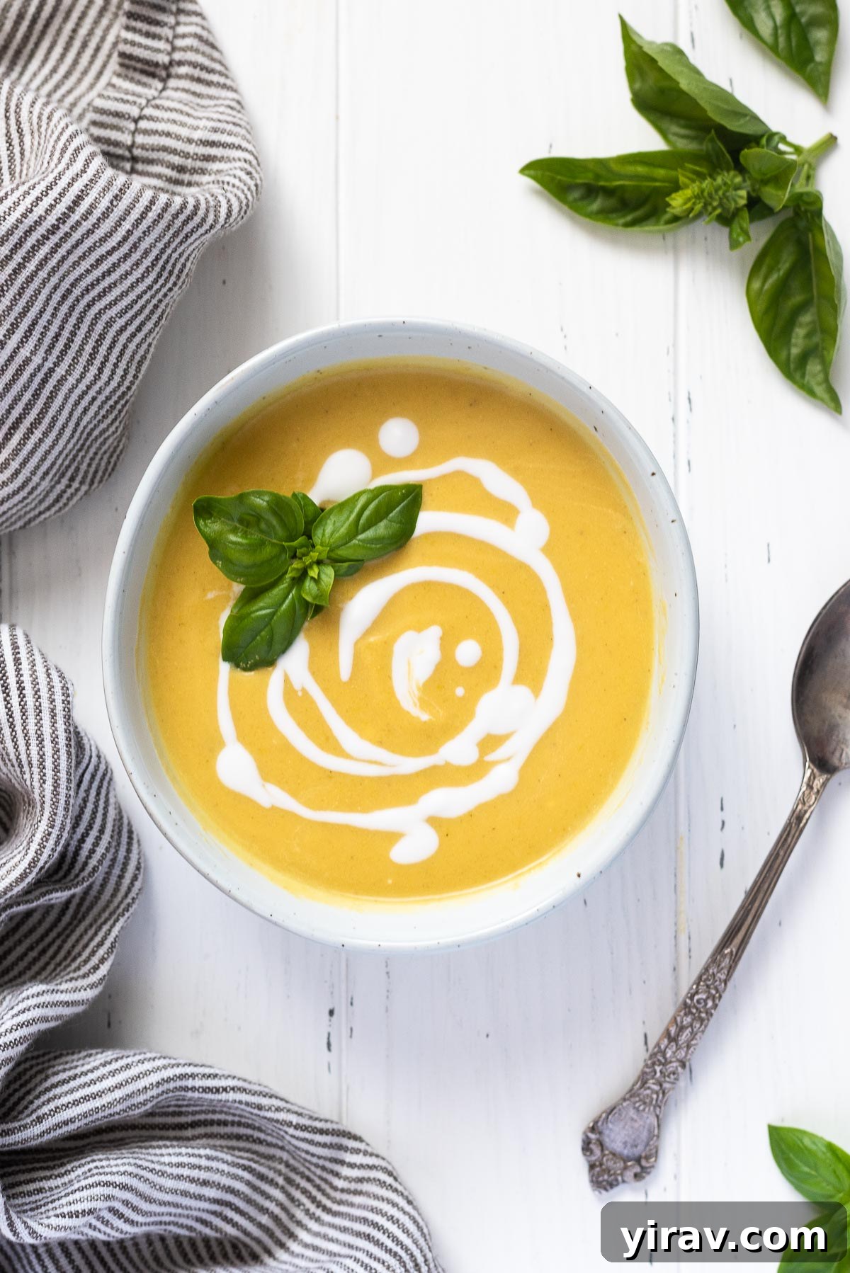 Summer squash soup with swirls of coconut milk and basil on top