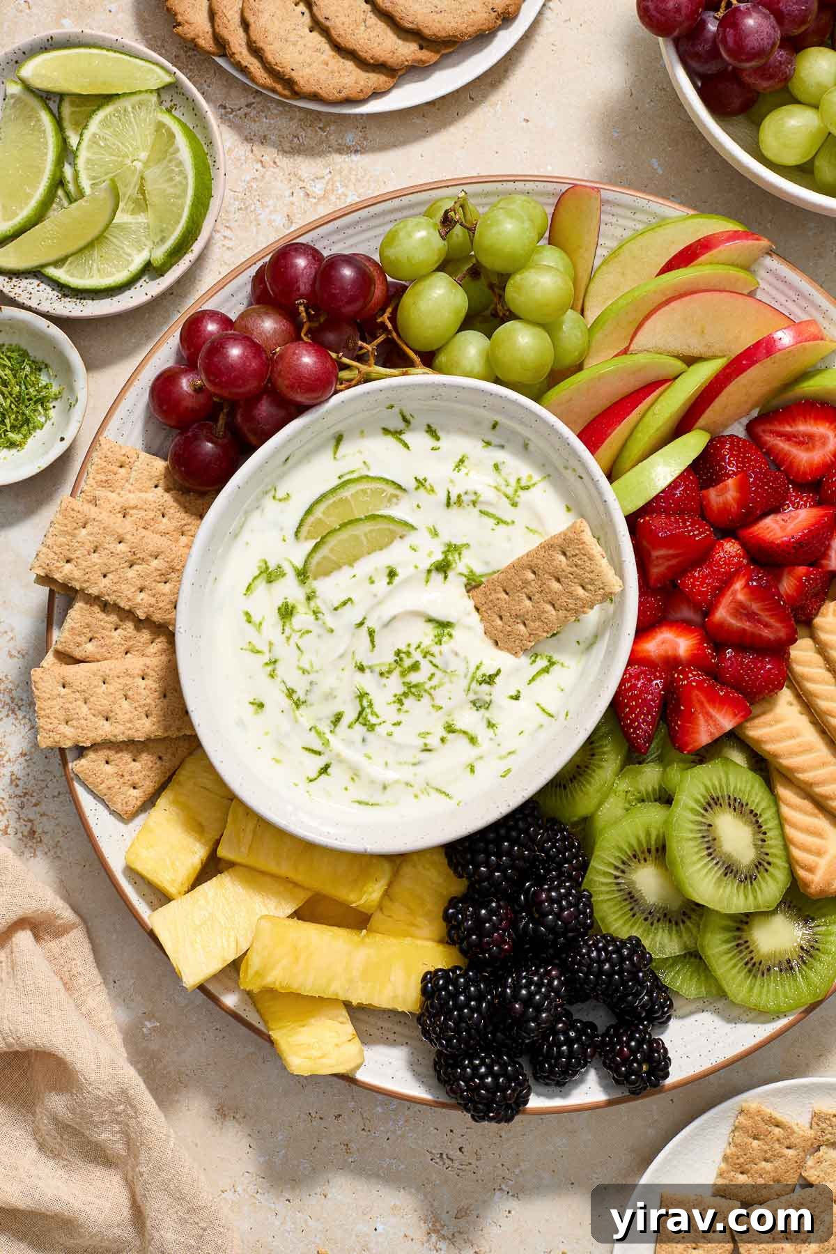 Key lime pie Greek yogurt dip in a bowl with graham cracker dipped in.