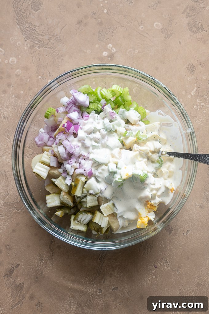 Potato salad ingredients in a mixing bowl.