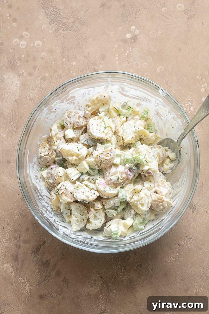 Finished dill pickle potato salad in a mixing bowl.