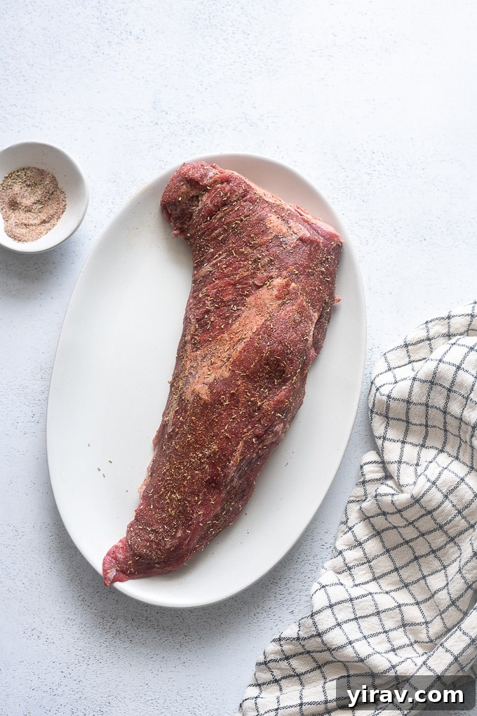 Close-up of Santa Maria style tri tip recipe ingredients laid out, including a tri tip roast, and various spices in small bowls.