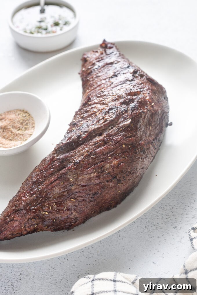 Beautifully arranged Santa Maria style grilled tri tip on a platter, ready for serving with side dishes.
